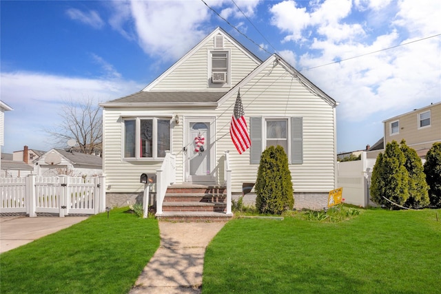 bungalow-style house featuring fence, entry steps, a gate, and a front yard