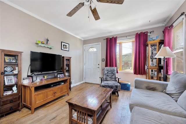 living room with baseboards, a ceiling fan, crown molding, and light wood-style flooring