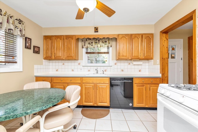 kitchen with a sink, decorative backsplash, black dishwasher, and white gas range