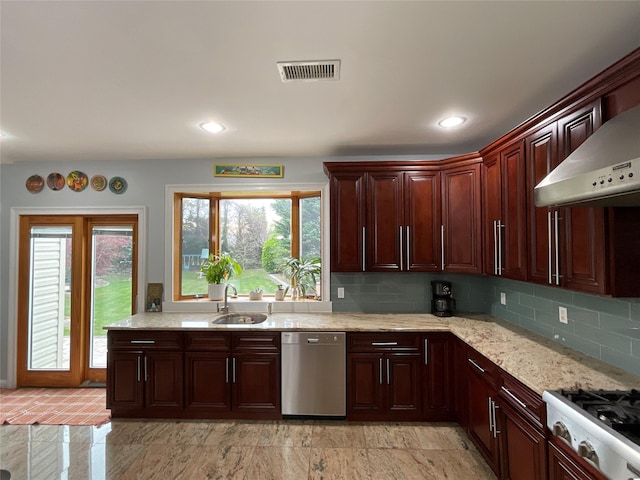 kitchen with stainless steel appliances, a sink, tasteful backsplash, visible vents, and light stone countertops