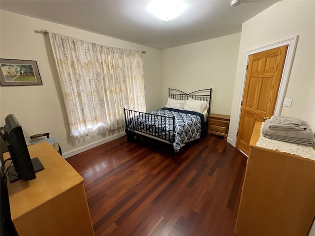 bedroom featuring baseboards and wood finished floors