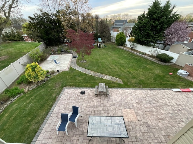 view of yard featuring a fenced backyard, a patio, and a playground