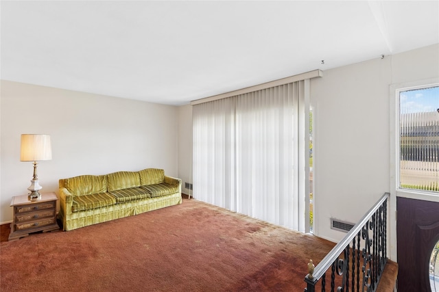 living room featuring carpet floors and visible vents