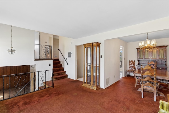 carpeted dining area with an inviting chandelier, stairway, and visible vents