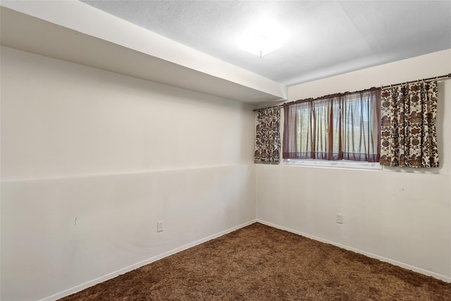 unfurnished room featuring carpet flooring and baseboards