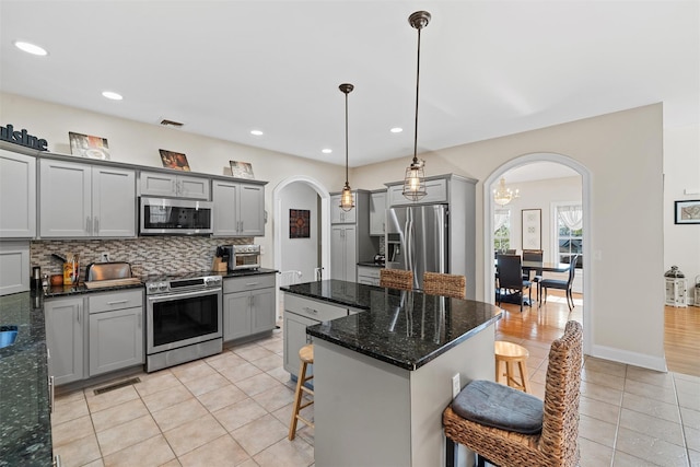 6 Fountayne Ct, Washingtonville, NY 10992 - kitchen with arched walkways, gray cabinets, and stainless steel appliances