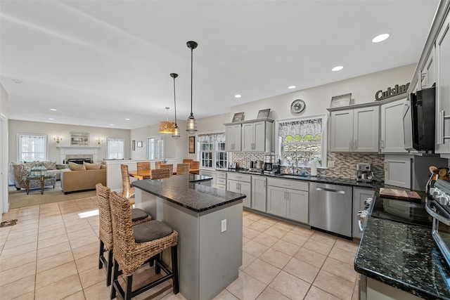 6 Fountayne Ct, Washingtonville, NY 10992 - kitchen featuring gray cabinets, tasteful backsplash, stainless steel dishwasher, a breakfast bar, and light tile patterned floors