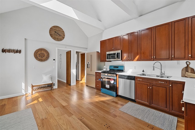 200 Fort Hill Rd, Scarsdale, NY 10583 - kitchen featuring stainless steel appliances, a sink, high vaulted ceiling, light countertops, and light wood-style flooring