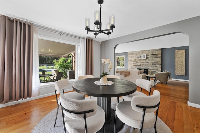 200 Fort Hill Rd, Scarsdale, NY 10583 - dining area with light wood-style floors, a chandelier, baseboards, and a fireplace