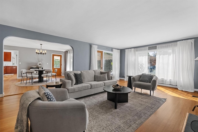 200 Fort Hill Rd, Scarsdale, NY 10583 - living room featuring a chandelier, plenty of natural light, and arched walkways