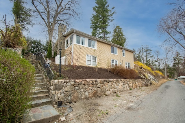 25 Evergreen Rd, Putnam Valley, NY 10579 - view of home's exterior with a chimney and stairs