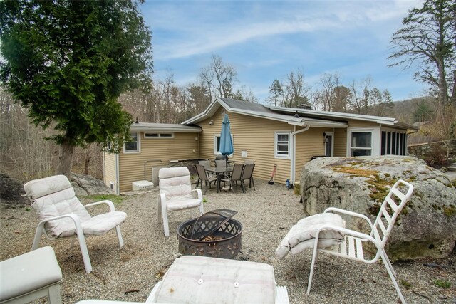 25 Evergreen Rd, Putnam Valley, NY 10579 - back of property with outdoor dining area, a patio, and an outdoor fire pit