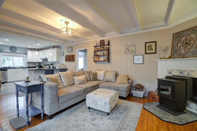 25 Evergreen Rd, Putnam Valley, NY 10579 - living room featuring an inviting chandelier, wood finished floors, beam ceiling, and a wood stove