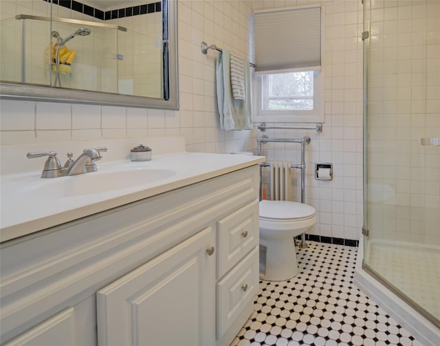 25 Evergreen Rd, Putnam Valley, NY 10579 - bathroom featuring a stall shower, vanity, tile walls, radiator, and tile patterned flooring