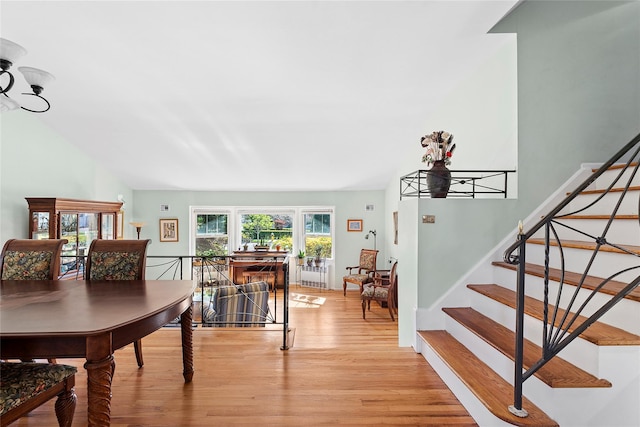dining area featuring stairs and light wood-style flooring