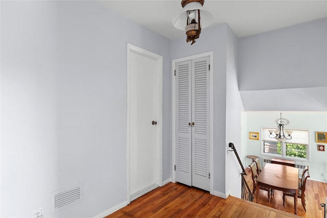 dining area with an inviting chandelier, wood finished floors, visible vents, and baseboards