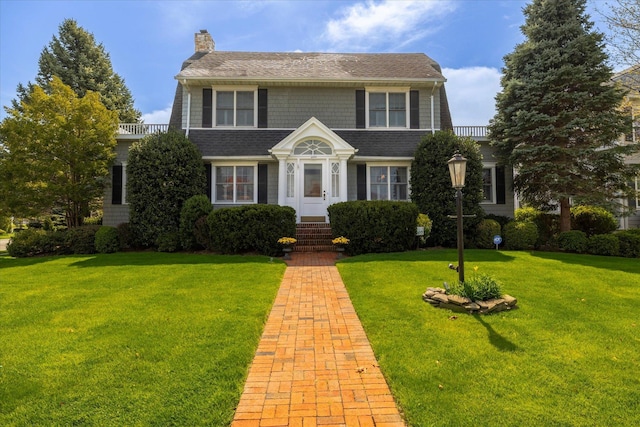 169 Hempstead Ave, Rockville Centre, NY 11570 - view of front of property featuring a front lawn and a chimney