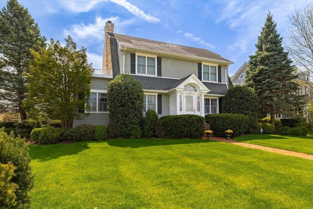 169 Hempstead Ave, Rockville Centre, NY 11570 - traditional-style house featuring a chimney and a front lawn