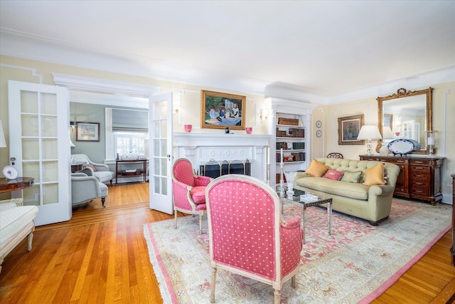 169 Hempstead Ave, Rockville Centre, NY 11570 - living room featuring a fireplace, wood finished floors, and french doors