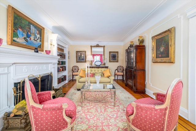 169 Hempstead Ave, Rockville Centre, NY 11570 - living area with baseboards, crown molding, wood finished floors, and a fireplace