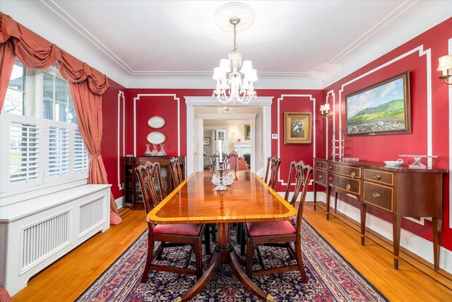 169 Hempstead Ave, Rockville Centre, NY 11570 - dining room with radiator heating unit, wood finished floors, baseboards, and an inviting chandelier