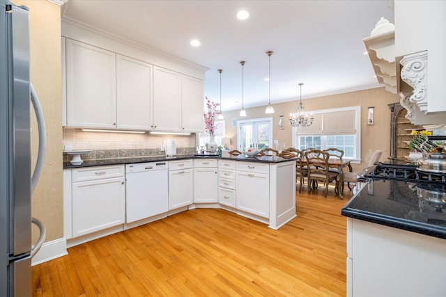 169 Hempstead Ave, Rockville Centre, NY 11570 - kitchen with dishwasher, a chandelier, light wood finished floors, and freestanding refrigerator