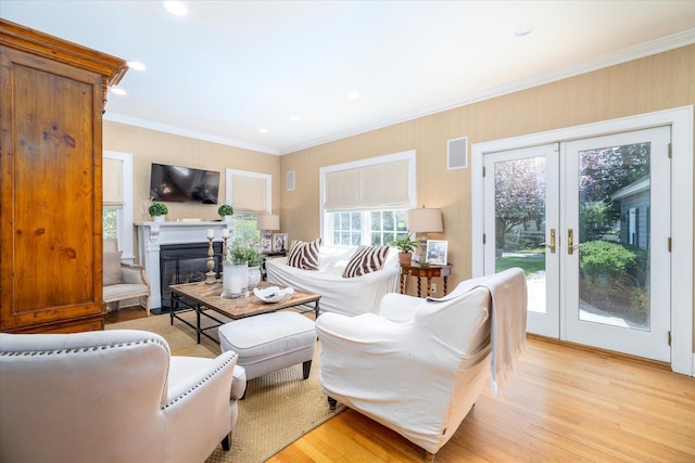169 Hempstead Ave, Rockville Centre, NY 11570 - living area with french doors, light wood-type flooring, a glass covered fireplace, visible vents, and ornamental molding