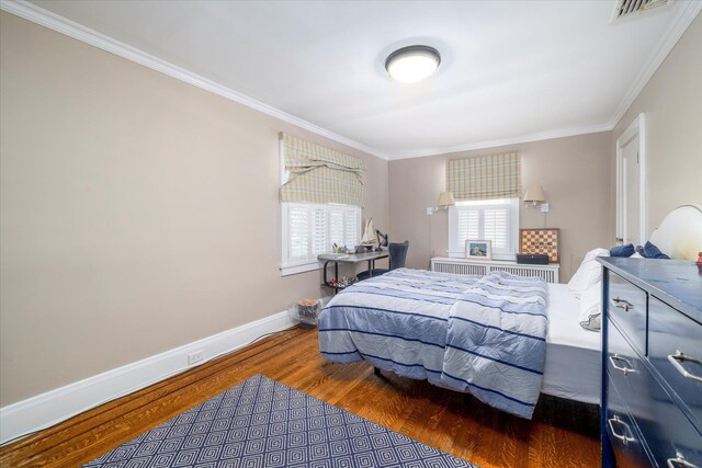 169 Hempstead Ave, Rockville Centre, NY 11570 - bedroom featuring radiator heating unit, wood finished floors, visible vents, and ornamental molding