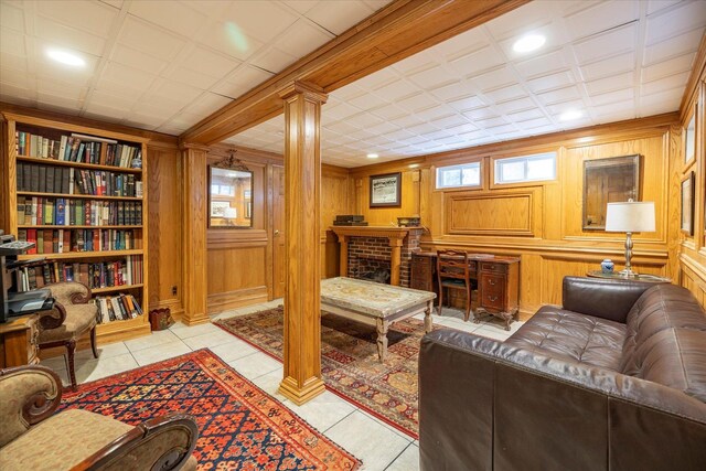 169 Hempstead Ave, Rockville Centre, NY 11570 - living room featuring decorative columns, wooden walls, and light tile patterned floors