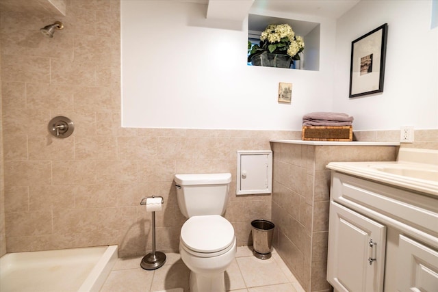 169 Hempstead Ave, Rockville Centre, NY 11570 - bathroom featuring toilet, tile walls, tiled shower, tile patterned flooring, and vanity