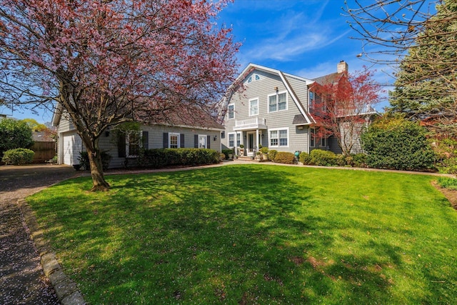 169 Hempstead Ave, Rockville Centre, NY 11570 - view of front of property with a gambrel roof, a chimney, a front lawn, driveway, and a garage