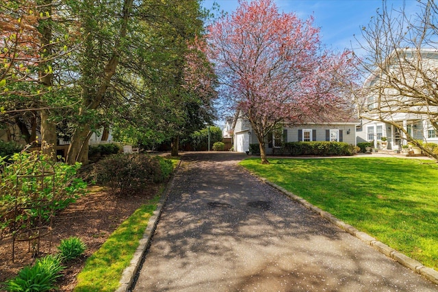 169 Hempstead Ave, Rockville Centre, NY 11570 - view of front of house featuring driveway, a front yard, and a garage