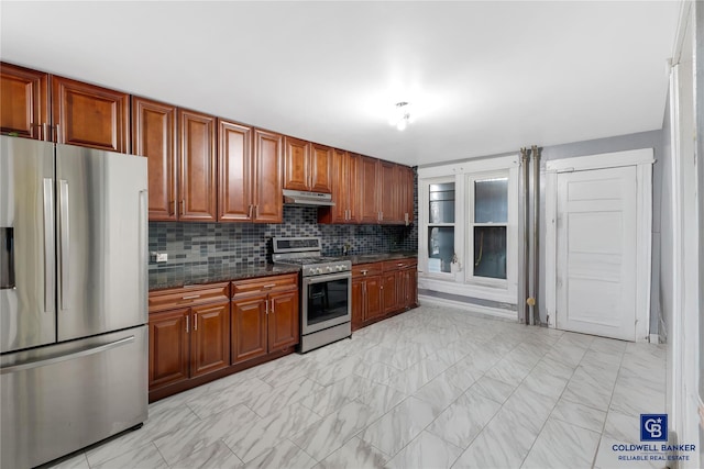 kitchen featuring marble finish floor, under cabinet range hood, stainless steel appliances, decorative backsplash, and brown cabinetry