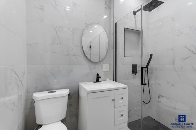 full bath featuring tile walls, toilet, vanity, and a walk in shower