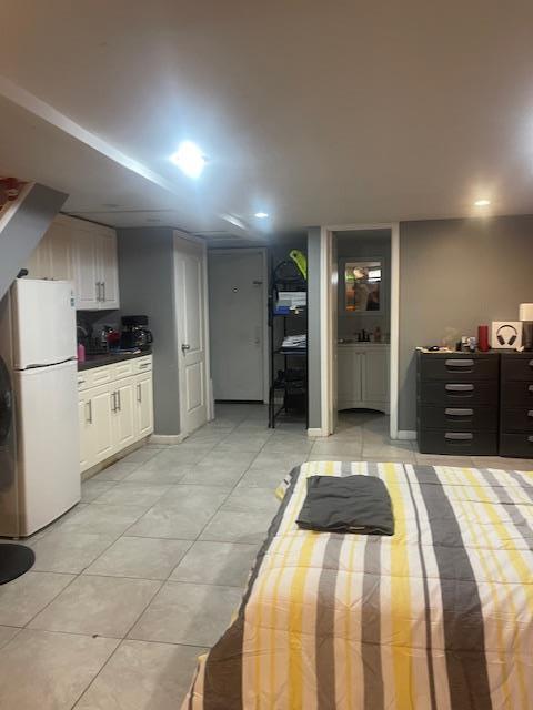1255 E 223rd St, Bronx, NY 10466 - bedroom featuring light tile patterned floors, freestanding refrigerator, and recessed lighting