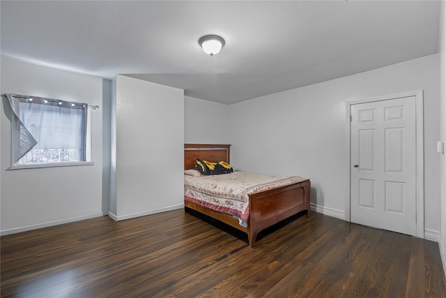 bedroom featuring wood finished floors and baseboards