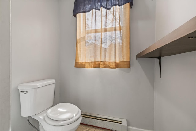bathroom featuring toilet and baseboard heating