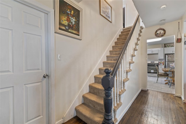 stairs with baseboards and hardwood / wood-style floors