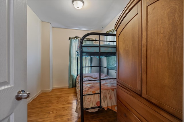 unfurnished bedroom featuring wood finished floors and baseboards