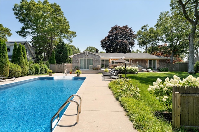 view of swimming pool featuring a fenced backyard, a fenced in pool, a yard, and a patio