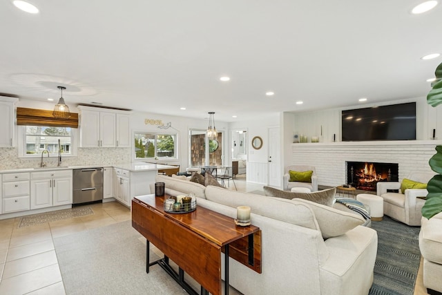 living room featuring recessed lighting, a fireplace, and light tile patterned floors