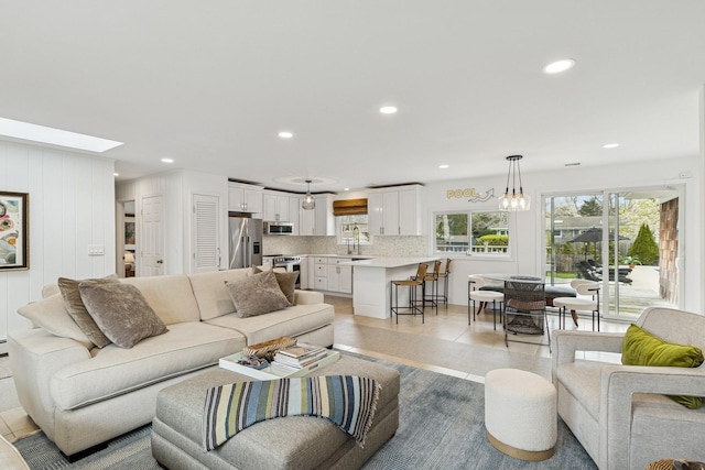 living room featuring a skylight and recessed lighting