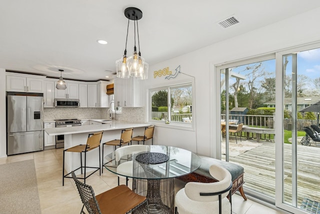 dining area with recessed lighting, visible vents, and light tile patterned floors