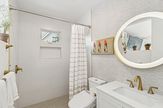bathroom featuring toilet, vanity, and tiled shower