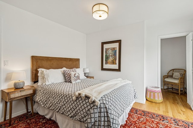 bedroom featuring wood finished floors and baseboards