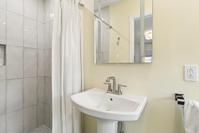 full bath with a sink and a stall shower