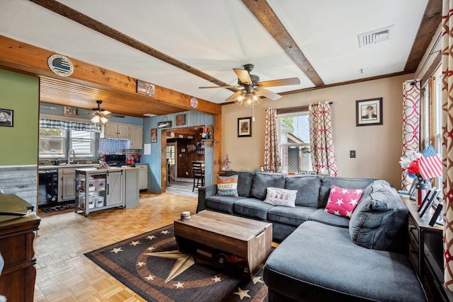 living room featuring ceiling fan, beam ceiling, and visible vents