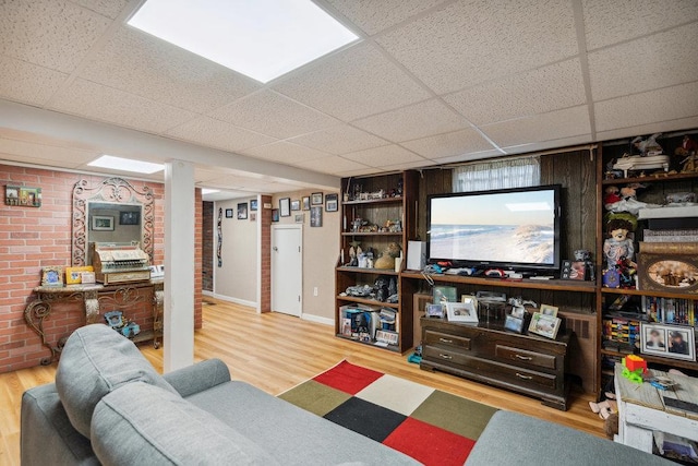 living room featuring wood finished floors and a paneled ceiling
