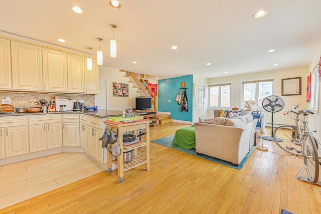 351 Bch 87th St, Rockaway Beach, NY 11693 - kitchen featuring cream cabinetry, open floor plan, tasteful backsplash, light wood-style floors, and a peninsula