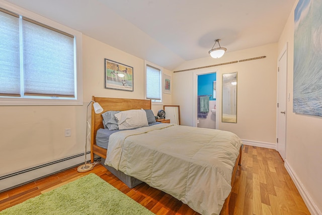 351 Bch 87th St, Rockaway Beach, NY 11693 - bedroom featuring a baseboard radiator, vaulted ceiling, multiple windows, and wood finished floors